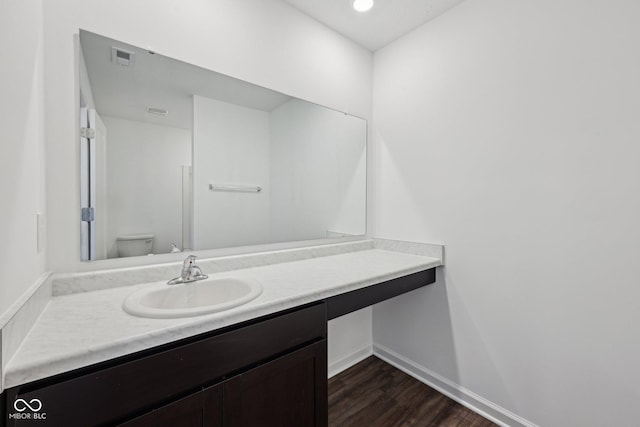 1304 Vera Blvd, Danville, IN 46122 - bathroom featuring wood finished floors, vanity, baseboards, and toilet