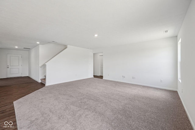 1304 Vera Blvd, Danville, IN 46122 - unfurnished living room featuring baseboards, stairway, recessed lighting, and dark carpet
