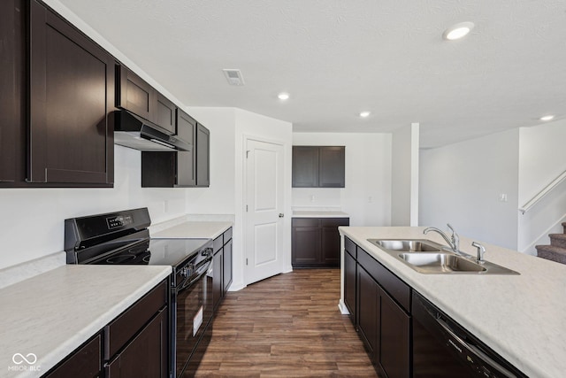 1304 Vera Blvd, Danville, IN 46122 - kitchen with black appliances, under cabinet range hood, a sink, dark wood-type flooring, and light countertops