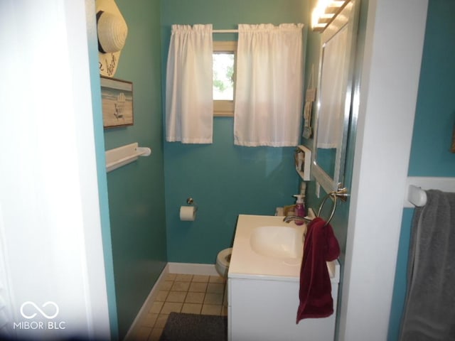 213 S Coventry Dr, Anderson, IN 46012 - bathroom featuring vanity, tile patterned floors, toilet, and baseboards