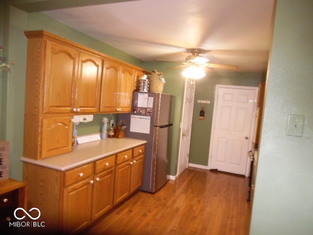 213 S Coventry Dr, Anderson, IN 46012 - kitchen with freestanding refrigerator, ceiling fan, wood finished floors, light countertops, and baseboards