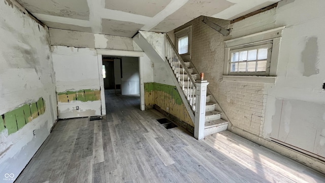 2955 N Olney St, Indianapolis, IN 46218 - basement featuring wood finished floors, stairway, and brick wall