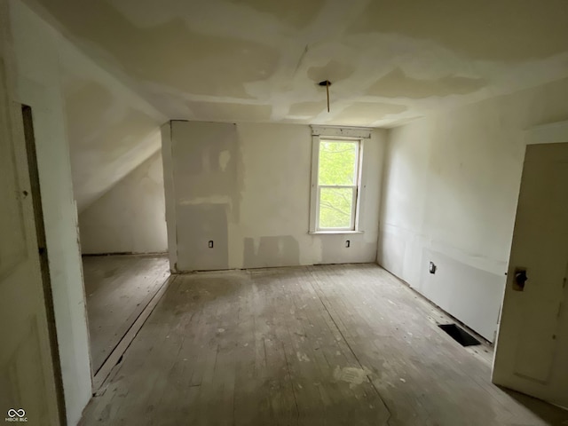 2955 N Olney St, Indianapolis, IN 46218 - bonus room featuring hardwood / wood-style floors and vaulted ceiling