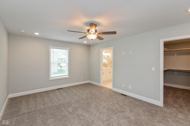 3204 N County Road 900 E, Seymour, IN 47274 - unfurnished bedroom with carpet floors, a walk in closet, recessed lighting, a closet, and ceiling fan
