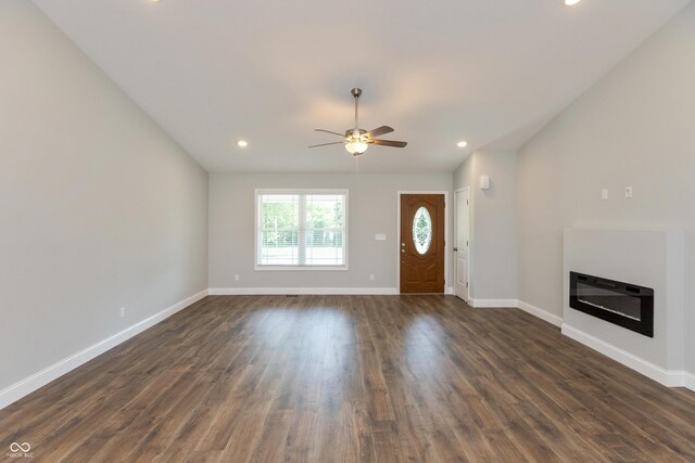 3204 N County Road 900 E, Seymour, IN 47274 - unfurnished living room featuring a ceiling fan, a glass covered fireplace, dark wood-style flooring, and recessed lighting