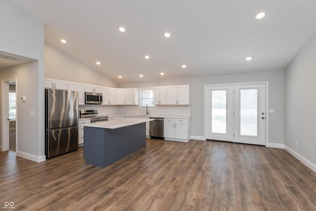 3204 N County Road 900 E, Seymour, IN 47274 - kitchen with appliances with stainless steel finishes, a kitchen island, white cabinets, vaulted ceiling, and light countertops