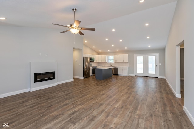 3204 N County Road 900 E, Seymour, IN 47274 - unfurnished living room featuring vaulted ceiling, a glass covered fireplace, ceiling fan, recessed lighting, and dark wood-style flooring
