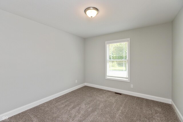 3204 N County Road 900 E, Seymour, IN 47274 - spare room with baseboards and dark carpet