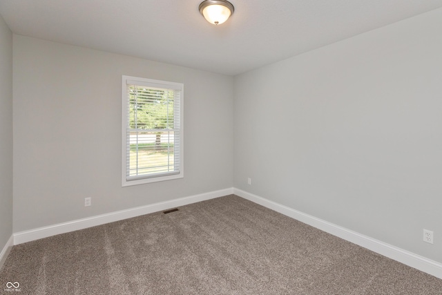 3204 N County Road 900 E, Seymour, IN 47274 - empty room featuring dark colored carpet and baseboards