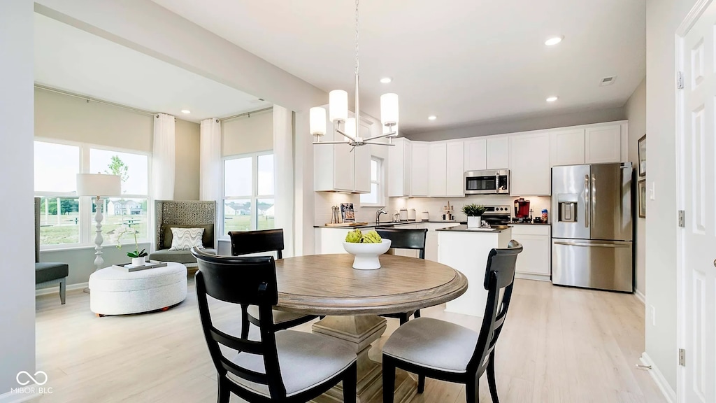 5002 Amber Wood Dr, Lawrence, IN 46235 - dining room featuring plenty of natural light, light wood-type flooring, baseboards, and recessed lighting