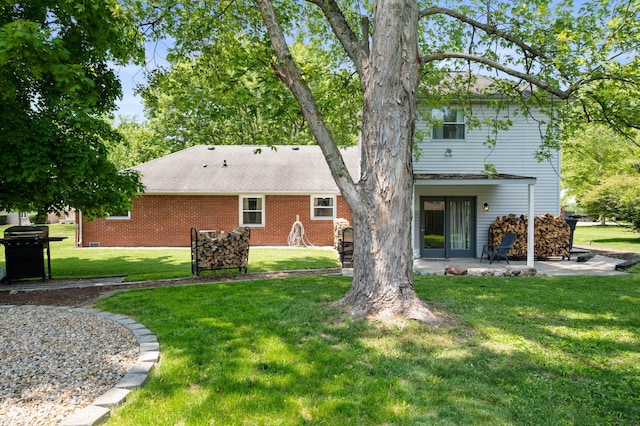 106 N Jamalee Way, Pendleton, IN 46064 - rear view of property featuring a patio area, a lawn, and brick siding