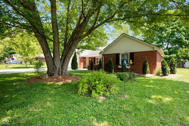 106 N Jamalee Way, Pendleton, IN 46064 - ranch-style house with brick siding, a front yard, and driveway