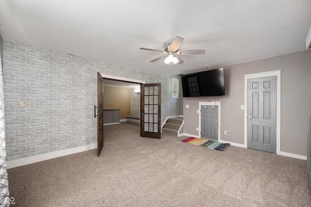 106 N Jamalee Way, Pendleton, IN 46064 - unfurnished living room featuring baseboards, ceiling fan, carpet flooring, and brick wall