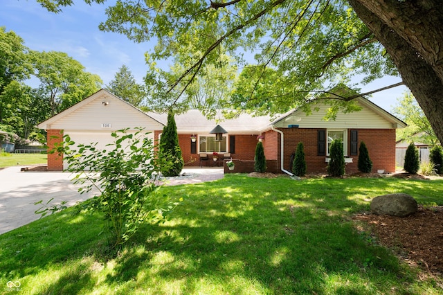 106 N Jamalee Way, Pendleton, IN 46064 - ranch-style home featuring concrete driveway, an attached garage, brick siding, and a front yard