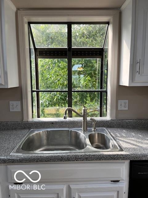 7707 River Rd Unit 10, Indianapolis, IN 46240 - kitchen view of a sink, white cabinets, dishwasher, and dark countertops