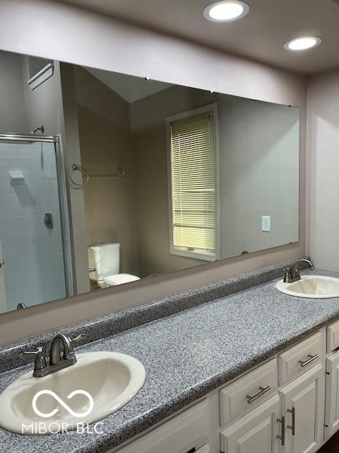 7707 River Rd Unit 10, Indianapolis, IN 46240 - full bathroom featuring double vanity and a shower stall