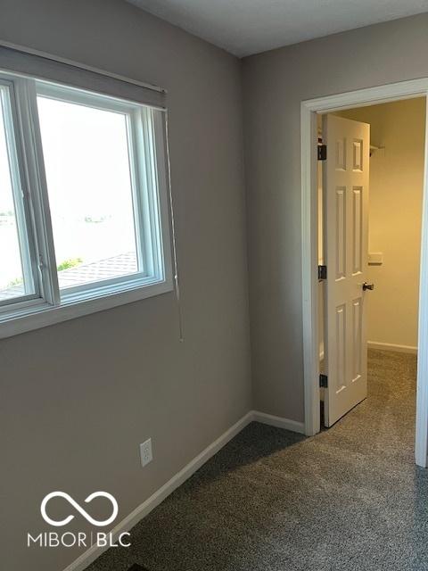 7707 River Rd Unit 10, Indianapolis, IN 46240 - spare room featuring plenty of natural light, baseboards, and carpet