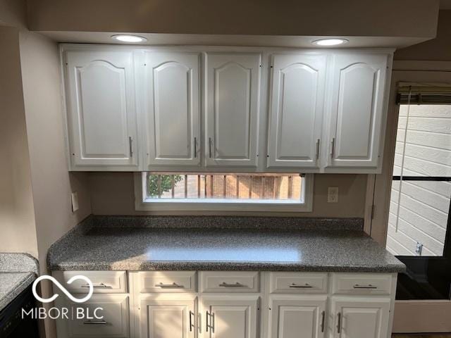 7707 River Rd Unit 10, Indianapolis, IN 46240 - kitchen with dark countertops and white cabinetry