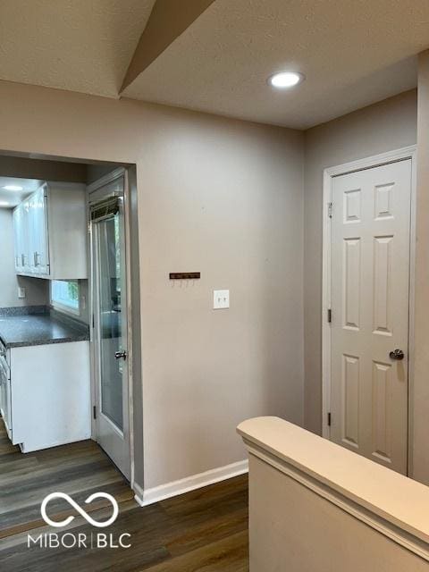 7707 River Rd Unit 10, Indianapolis, IN 46240 - hall with baseboards, dark wood-style flooring, and recessed lighting