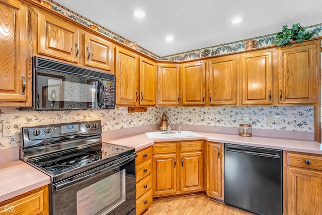 6605 N Private Road 110 W, Brazil, IN 47834 - kitchen featuring black appliances, light countertops, light wood-style floors, brown cabinets, and recessed lighting