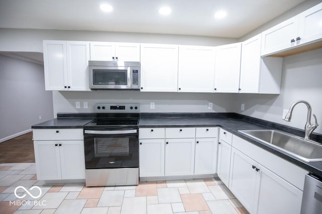 5840 N State Highway 7, Scipio, IN 47273 - kitchen featuring stainless steel appliances, a sink, white cabinetry, recessed lighting, and dark countertops