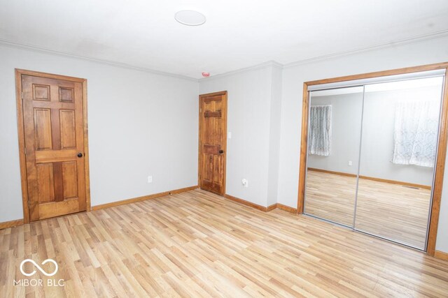 5840 N State Highway 7, Scipio, IN 47273 - unfurnished bedroom featuring light wood-style flooring, a closet, ornamental molding, and baseboards