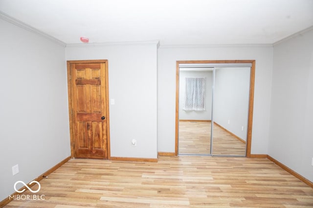 5840 N State Highway 7, Scipio, IN 47273 - unfurnished bedroom with light wood finished floors, baseboards, a closet, and ornamental molding