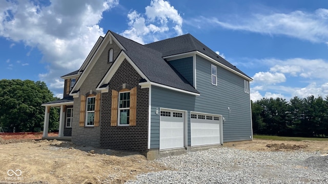 1919 Delp Ct, Avon, IN 46123 - view of side of home with a shingled roof and gravel driveway