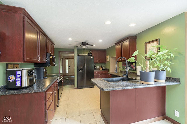 5110 S State Ave, Indianapolis, IN 46227 - kitchen with black fridge, a sink, stainless steel range with electric stovetop, a peninsula, and a ceiling fan
