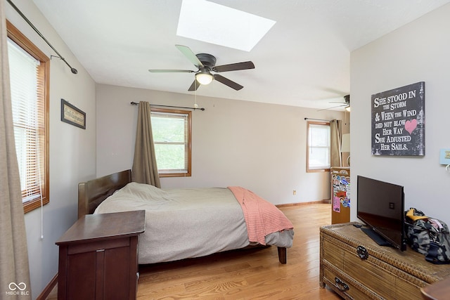 5110 S State Ave, Indianapolis, IN 46227 - bedroom with light wood finished floors, multiple windows, a skylight, and baseboards