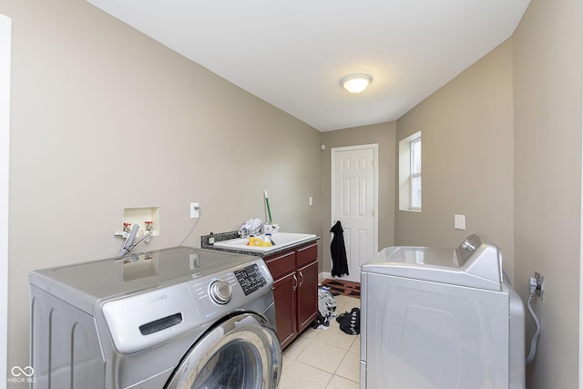 5110 S State Ave, Indianapolis, IN 46227 - laundry room with cabinet space, washing machine and dryer, and light tile patterned floors
