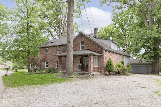 5110 S State Ave, Indianapolis, IN 46227 - view of front facade featuring a porch, brick siding, a front lawn, and a chimney