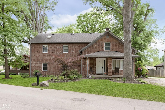 5110 S State Ave, Indianapolis, IN 46227 - view of front of house with covered porch, a front lawn, brick siding, and roof with shingles