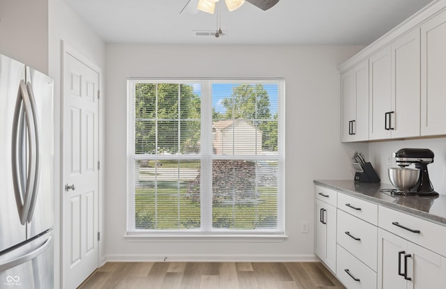 1819 Quiet Haven Cir, Indianapolis, IN 46229 - kitchen featuring freestanding refrigerator, a ceiling fan, white cabinets, and light wood-style flooring