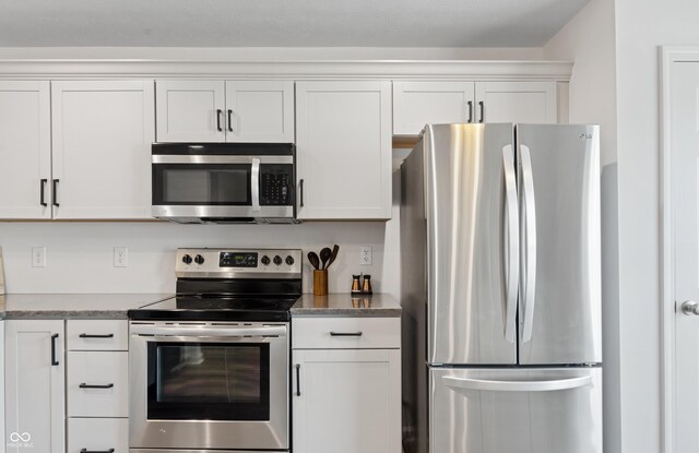 1819 Quiet Haven Cir, Indianapolis, IN 46229 - kitchen with appliances with stainless steel finishes, white cabinets, and light stone counters