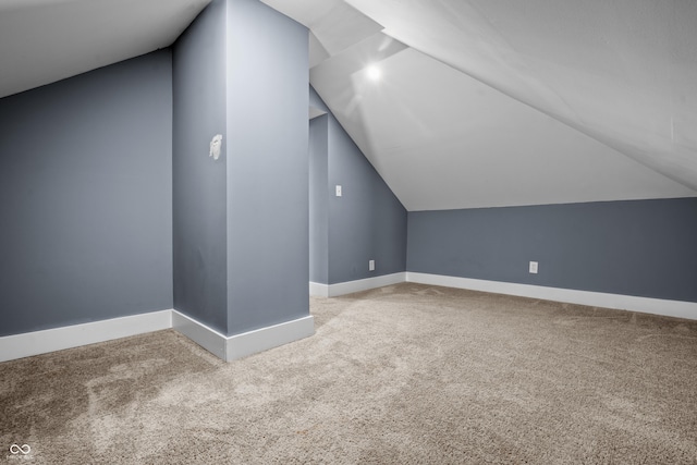 1529 E Tabor St, Indianapolis, IN 46203 - additional living space featuring carpet floors, vaulted ceiling, and baseboards