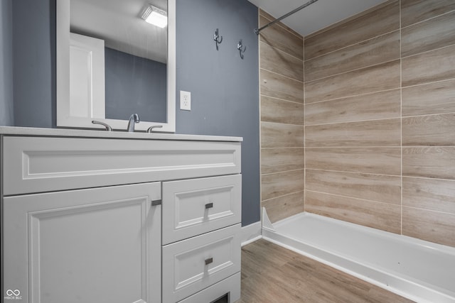 1529 E Tabor St, Indianapolis, IN 46203 - bathroom featuring a tile shower, vanity, and wood finished floors