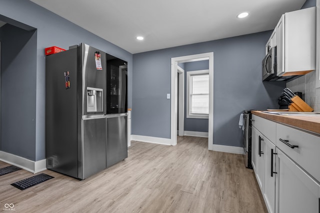 1529 E Tabor St, Indianapolis, IN 46203 - kitchen with appliances with stainless steel finishes, baseboards, light wood-style floors, white cabinets, and recessed lighting
