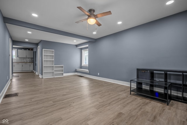 1529 E Tabor St, Indianapolis, IN 46203 - unfurnished living room featuring a ceiling fan, wood finished floors, baseboards, and recessed lighting