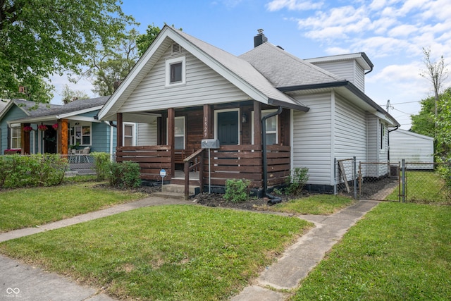 1529 E Tabor St, Indianapolis, IN 46203 - bungalow-style house with a porch, a chimney, and a gate