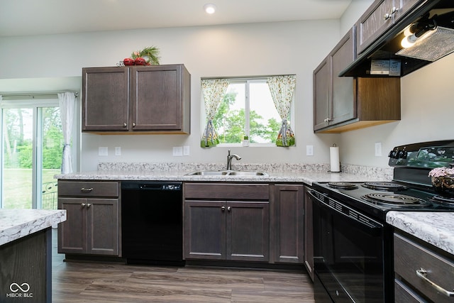 5335 Rum Cherry Way, Indianapolis, IN 46237 - kitchen with black appliances, extractor fan, light countertops, dark brown cabinets, and recessed lighting
