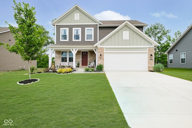 5335 Rum Cherry Way, Indianapolis, IN 46237 - view of front of property featuring board and batten siding, covered porch, brick siding, and a front yard