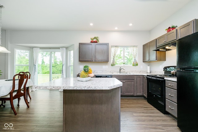 5335 Rum Cherry Way, Indianapolis, IN 46237 - kitchen featuring black appliances, under cabinet range hood, light countertops, a center island, and recessed lighting