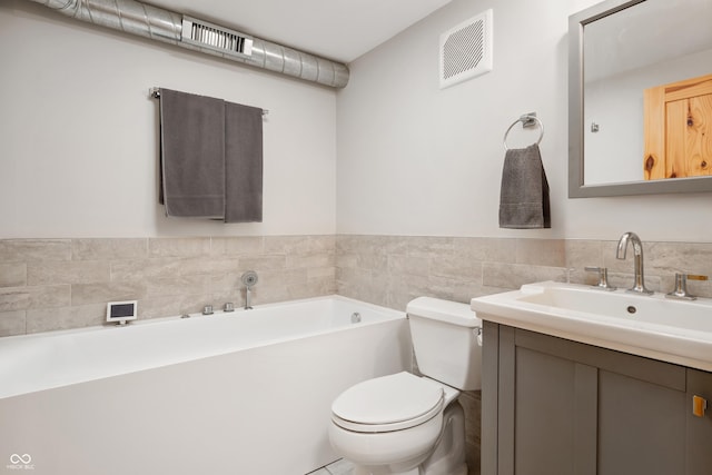 8426 N Chickadee Dr, Morgantown, IN 46160 - bathroom featuring toilet, a garden tub, and vanity