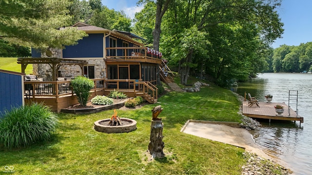 8426 N Chickadee Dr, Morgantown, IN 46160 - rear view of property with an outdoor fire pit, stone siding, a deck with water view, stairway, and a yard