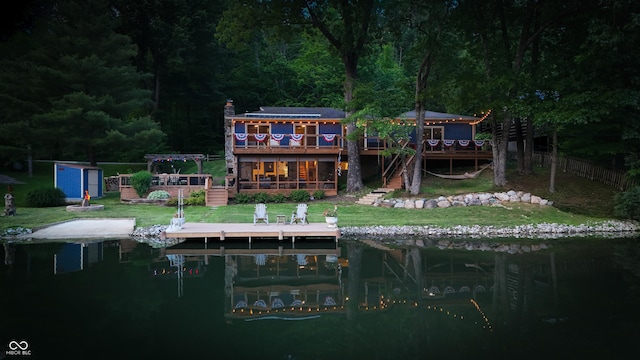 8426 N Chickadee Dr, Morgantown, IN 46160 - back of house with a wooden deck, stairs, a wooded view, and a chimney