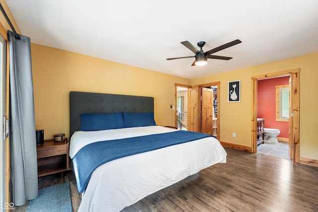 8426 N Chickadee Dr, Morgantown, IN 46160 - bedroom featuring wood finished floors, baseboards, ceiling fan, a walk in closet, and ensuite bath