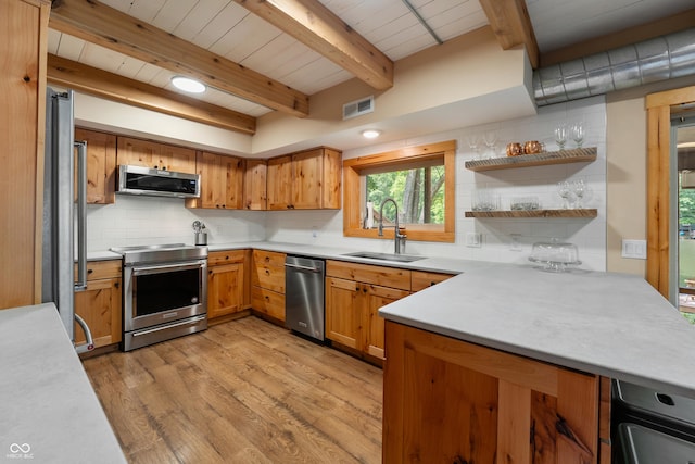 8426 N Chickadee Dr, Morgantown, IN 46160 - kitchen featuring a sink, appliances with stainless steel finishes, backsplash, light countertops, and light wood-style floors
