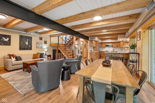 8426 N Chickadee Dr, Morgantown, IN 46160 - dining area featuring light wood-type flooring, stairway, and beam ceiling