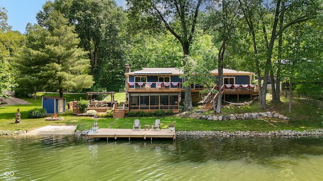 8426 N Chickadee Dr, Morgantown, IN 46160 - back of property with a deck with water view, stairs, and a sunroom